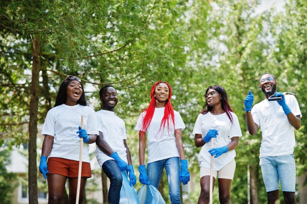 group-happy-african-volunteers-with-garbage-bags-cleaning-area-park-africa-volunteering-charity-people-ecology-concept_627829-388